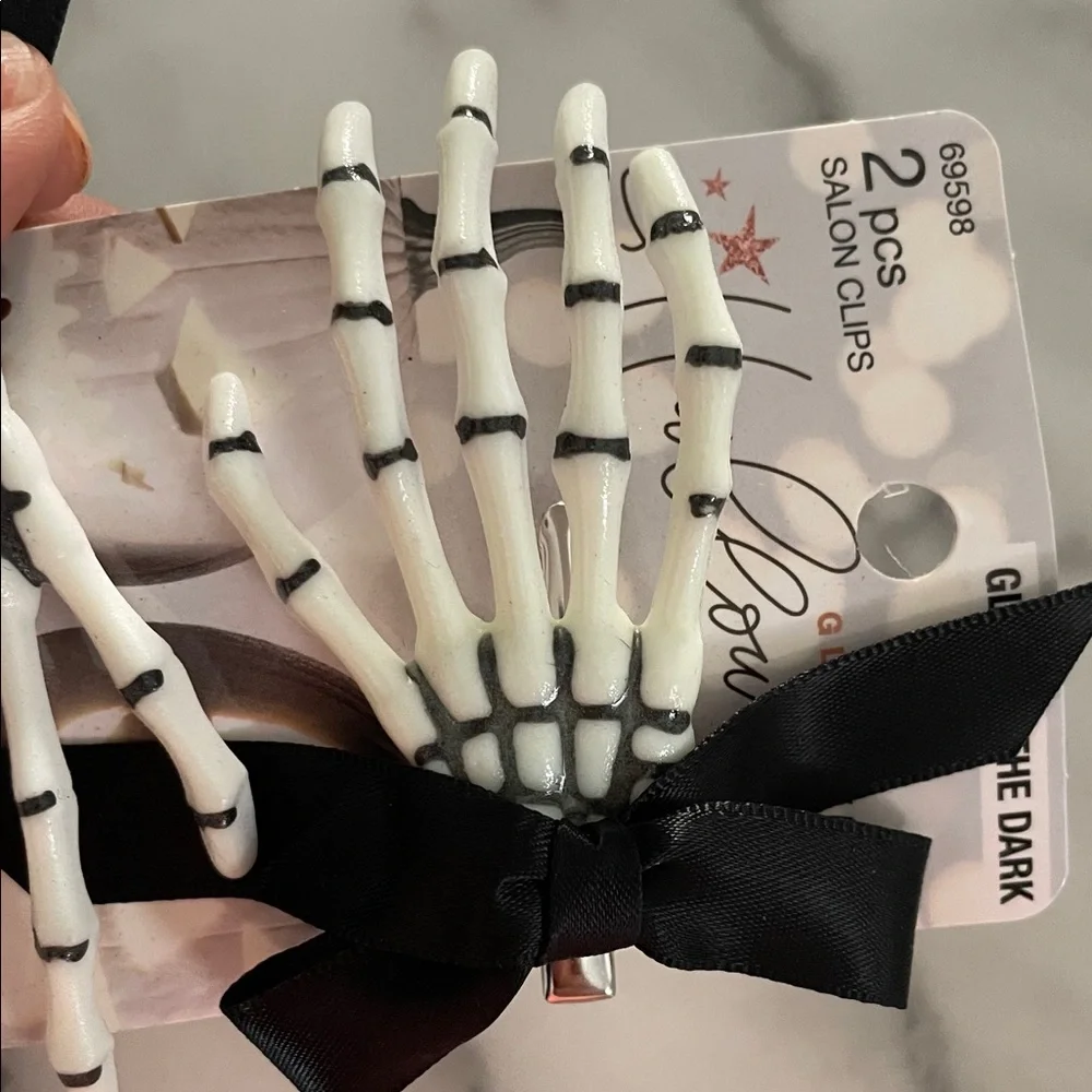 These are Scunci Glamoween Glow-in-the-Dark Skeleton Hand Hair Clips Halloween